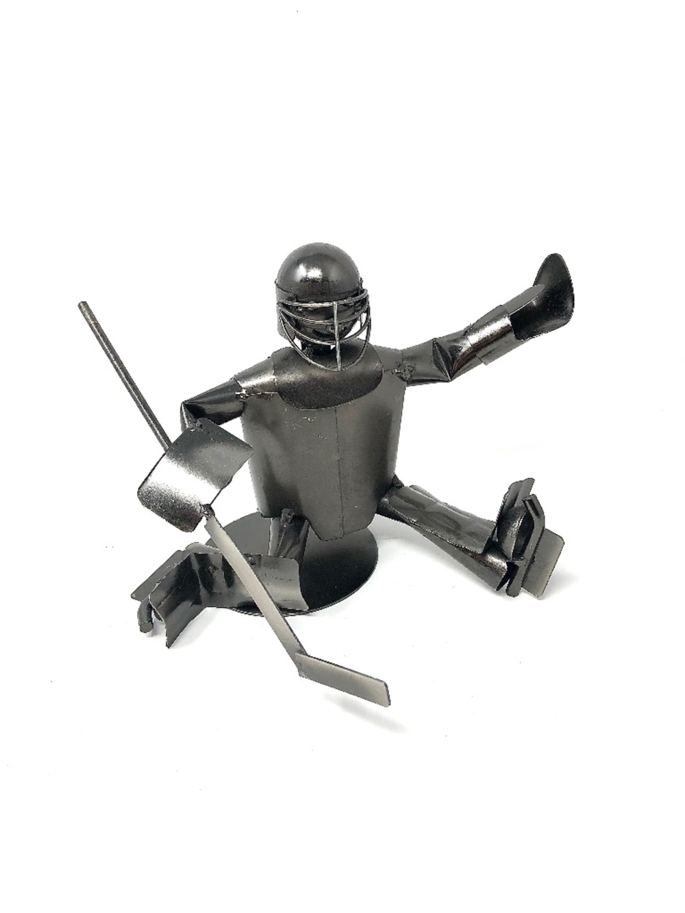 Handmade metal sculpture of a hockey goalie making a save